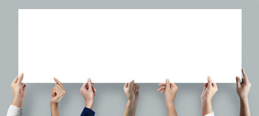 Many hands holding a long blank poster for advertising on grey background.