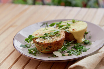 Quiche vegan healthy gluten free muffins with almond flakes, tofu, pea sprouts, greens, vegetables. Healthy food breakfast.