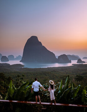 young men and women on vacation in Thailand visiting the bay of Phannga famous for watching the sunrise at Samet Nang She viewpoint. Couple of men and women watching the sunrise at Samet Nang She's