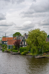 Obraz premium Rural landscape with windmill in Zaanse Schans. Holland, Netherlands. Authentic Zaandam mill. Beautiful Netherland landscape.