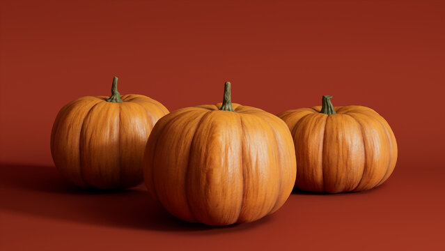 Three Pumpkins on a Deep Orange colored background. Autumn themed Wallpaper.