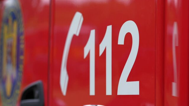 112 emergency service European number used to call in case of danger. Concept 4K video with 112 on an emergency firefighters truck.