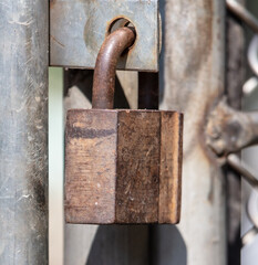 Old rusty metal lock on the door.