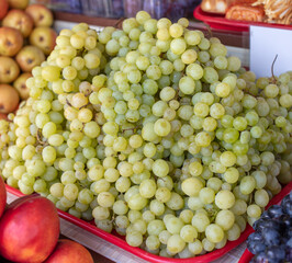 Green grapes on the counter in the market.