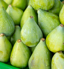 Green figs on the counter in the market.