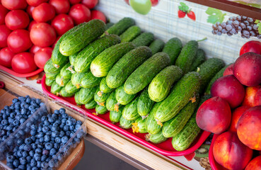 Green cucumbers on the counter in the market.