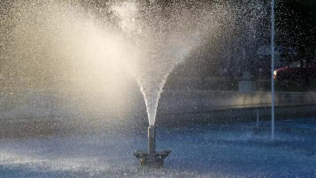 Detail view of the water drops, jet and the sprinkler system part from a dancing singing fountain in the middle of the city. Beautiful ways to entertain the tourists. 4k video.