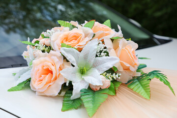 Flowers on a car as decoration at a wedding.