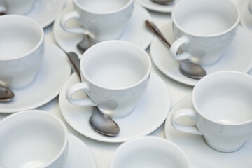 White tea cups with spoons