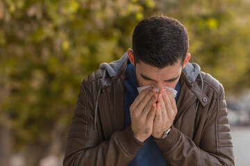 Man with allergy or an infection sneezing