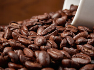 Coffee cup and coffee beans on a wooden background. View from above.