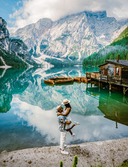 Prager Wildsee, a Spectacular romantic place with typical wooden boats on the alpine lake, Lago di Braies, Braies lake, Dolomites, South Tyrol, Italy, Europe. couple on vacation Dolomites