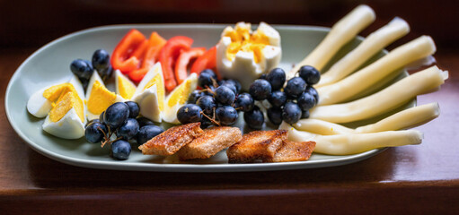 Boiled egg, grape of wine, cheese, red pepper and roasted bread.