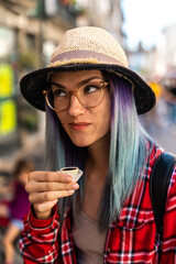 Tourist drink ginja liqueur from small cup made of chocolate - traditional portuguese cherry liqueur