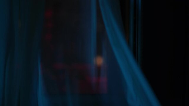 window with the background of the night. curtains fluttering in the wind.