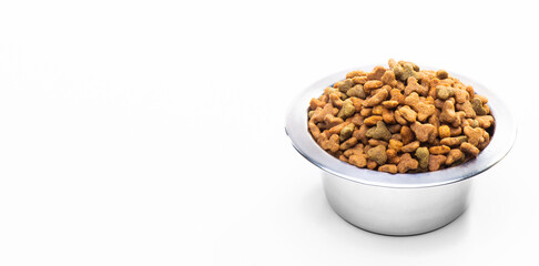 Metal bowl with dry food for cats and dogs isolated on white background