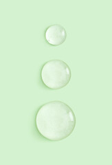 drop of serum gel cosmetic essence on a light pastel background