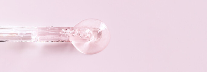 banner glass pipette serum closeup on a light pink background