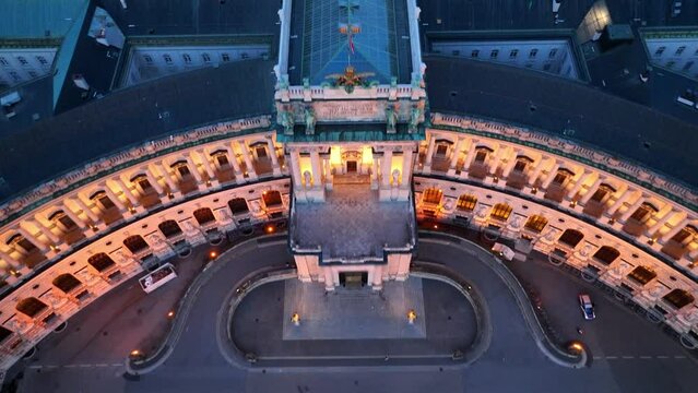 Aerial view of Vienna at night with illuminated historic touristic landmark, Hofburg palace facade in the evening light in Vienna city centre