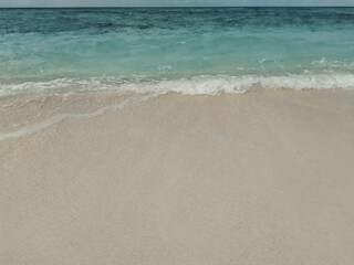 Maldives, a beach with the white sand near the turquoise ocean.