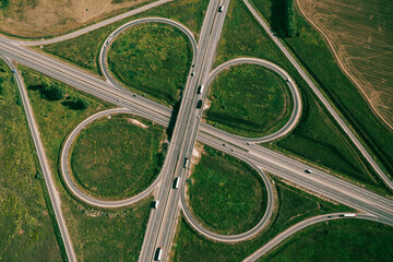 Clover or daisy type of road junction. Aerial top down view of beautiful highway road junction in...