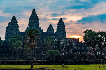 Cambodia. Siem Reap Province. Sunrise at Angkor Wat (Temple City) at early morning.  A Buddhist and temple complex in Cambodia and the largest religious monument in the world. View from the garden