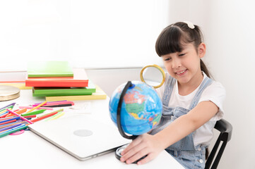 Kids girl funny with use magnifying glass in living room at home	