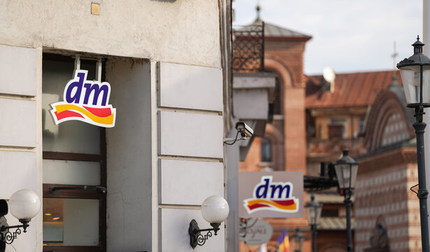The logo sign of DM (drogerie markt) Pharmacy healthcare and beauty products on top of a store from Bucharest, Romania, 2022.