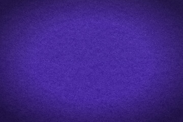 Fototapeta premium Texture of navy blue and violet colors paper background with dark vignette, macro. Structure of craft indigo cardboard.