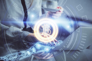 Double exposure of woman hands typing on computer and crypto market theme hologram drawing. Blockchain concept.