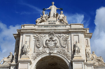 Monument and statues at Lisbon Main Square; Lisbon, Portugal, Europe. This historical Triumphal Arch is the gate that connects Lisbon to the Tagus river. Commerce Square view with Rua Agusta.