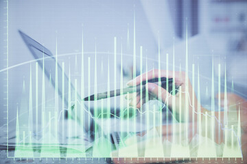 Multi exposure of woman hands typing on computer and financial graph hologram drawing. Stock market analysis concept.