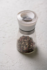 glass pepper mill on white background