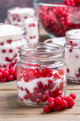 Schisandra chinensis jam on wooden table. Five-flavor berries with sugar in a glass jar