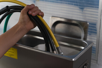 Person holding compressed air conveying hoses