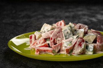 close-up shot of salad with tomatoes and cucumbers on black