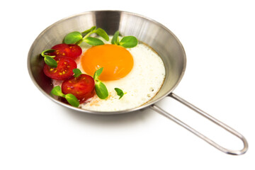 Scrambled eggs with tomatoes and micro greens isolated on white background with clipping path.