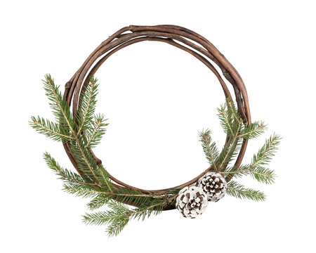 Christmas and New Year frame. Round frame of willow rods, spruce branches and two pine cones. Natural winter background.