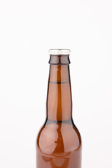 Image of brown glass full lager beer bottle with crown cap, with copy space on white background