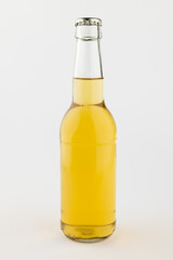 Image of clear glass full lager beer bottle with crown cap, with copy space on white background