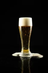 Foto op Canvas Image of overflowing pint glass of foamy beer, with copy space on black background © vectorfusionart