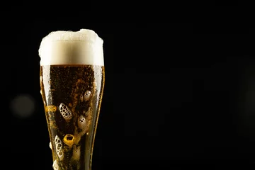 Foto op Canvas Image of full pint glass of foamy beer, with copy space on black background © vectorfusionart