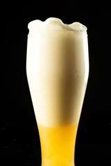 Foto op Canvas Image of overflowing pint glass of foamy beer, with copy space on black background © vectorfusionart
