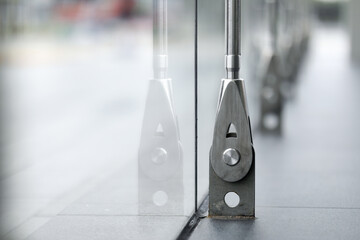 Closeup Stainless fasteners elements of glass curtain walls system.