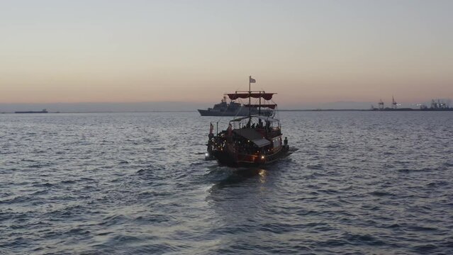 Aerial - Trireme (traditional greek boat) in Thessaloniki Greece at dusk