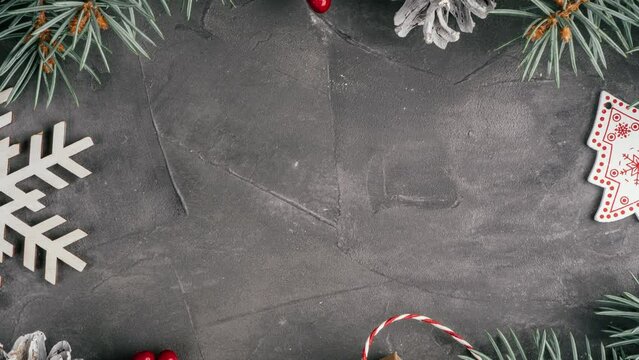Stop motion video of numbers 2023 appearing on gray concrete background with branches of Christmas tree. Merry Christmas and Happy New Year 2023. Top view