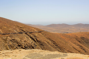 Fototapeta na wymiar Road in vulcanic landscape of Fuerteventura Island, Canary Island, Spain, Europe.