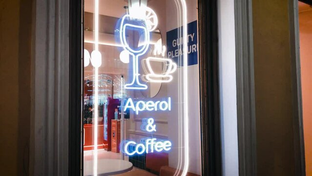 bar cafe neon sign aperol and coffee window showcase. High quality 4k footage. Nightlife visitors