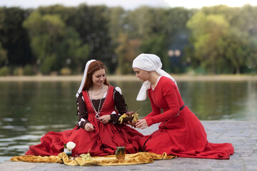 A living history: a 15th-century woman dressed as a wealthy lady in a Venice dress, her maid...