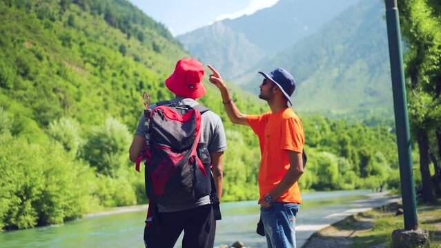 Camera follows man on trip or adventure. Young millennial traveller or travel blogger walk in beautiful mountain valley and make photos for social media or memories. Generation z new concept travels